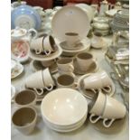 A Poole pottery six setting dinner and tea service, including dinner and side plates , bowls , cups,