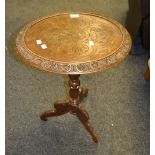 A mid 20th Century carved mahogany lamp table, carved tripod base.