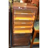 An early 20th century oak tambour fronted stationery cabinet fitted with 9 drawers