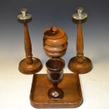 Treen - a pair of turned candlesticks; crumb tray; a turned goblet;