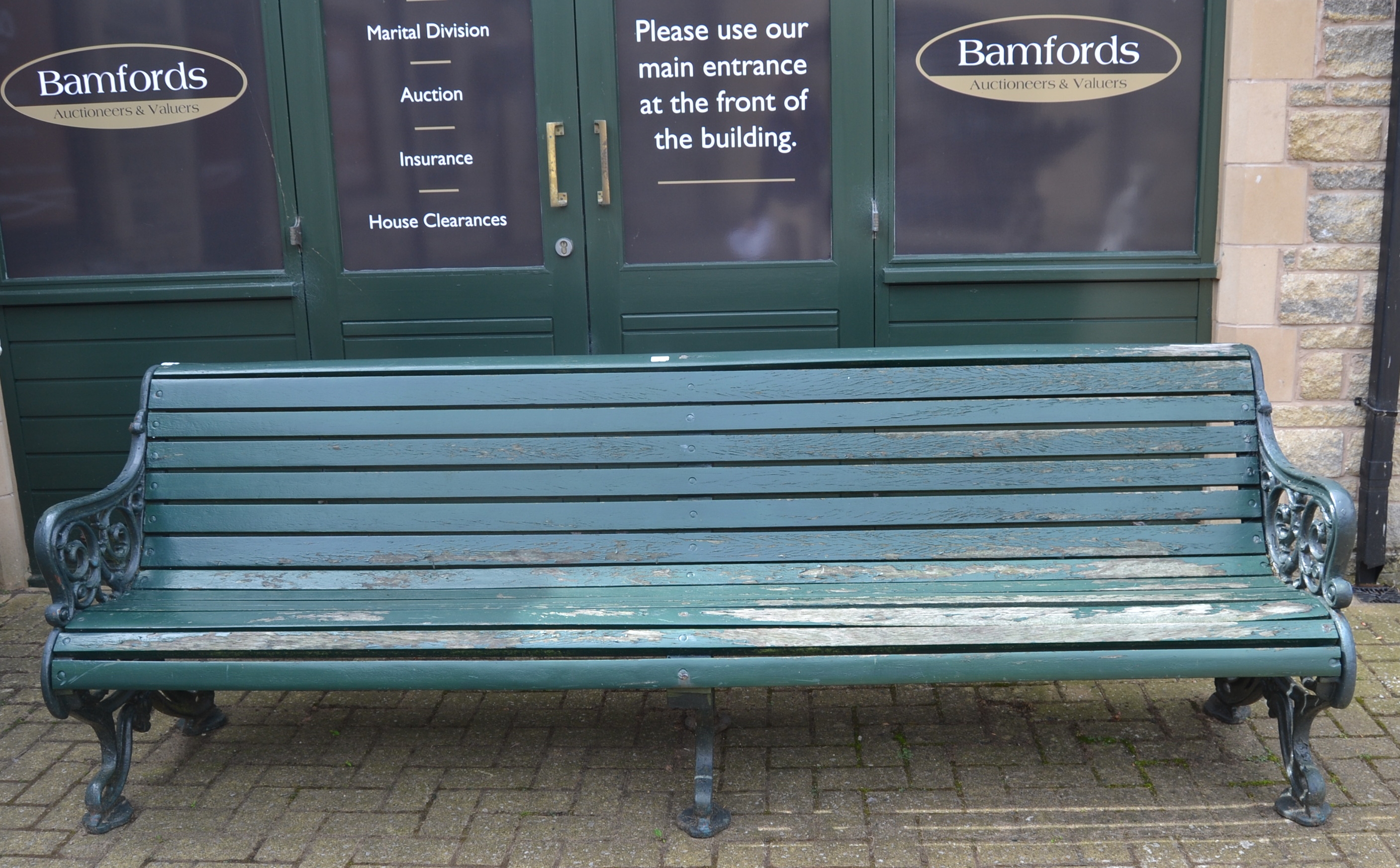 A Victorian Coalbrookdale style cast iron and slatted wood garden bench, acanthus scroll ends,