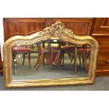 A Rococo-style, gilt, framed, over-mantel mirror.