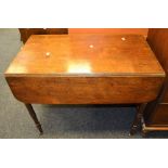 An early 20th Century mahogany drop leaf table, turned supports.