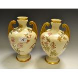 A pair of Royal Worcester two-handled pedestal ovoid vases,