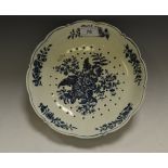 A Worcester Pomegranate pattern shaped circular strainer dish, printed with pomegranate,