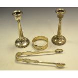 A pair of George V silver boudoir candlesticks, tapering octagonal columns,