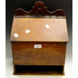 A 19th century oak candle box, pierced cresting with suspension loop,