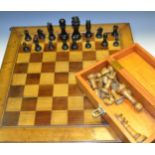 A pitch walnut and mahogany chess board,