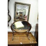 An Edwardian mahogany oval dressing table mirror;