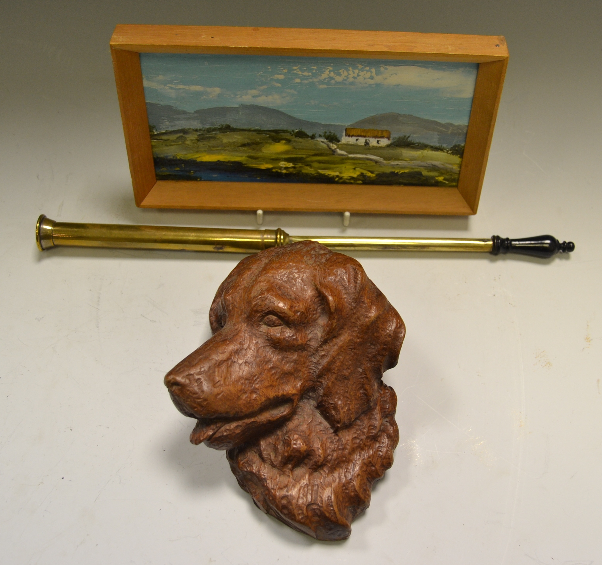 A primitive Irish miniature oil on board, Distant Hills; a carved head of a Collie Dog,