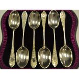 A set of six late Victorian silver teaspoons, chased with descending roses and foliate leaves,