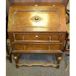 An early 20th Century oak fall front bureau, enclosed pigeon holes,