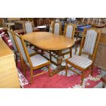 A Parker Knoll oak D-end extending dining table, trestle base with carved cup and cover supports,