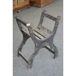 A late 19th Century ebonised X frame chair, carved with leaves, c.