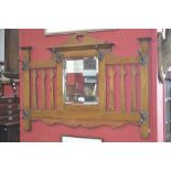 An oak Arts and Crafts coat rack, arched pediment with heart shaped piercing,