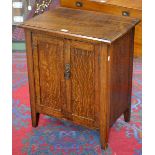 An early 20th century oak low hall cupboard, Arts and Crafts handle, tapered square legs, c.