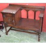 A Jaycee dark oak telephone table.