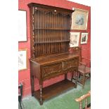 A 20th century Jacobean style dresser, outswept cornice, shaped uprights, two drawers,