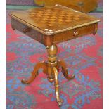 A Victorian mahogany games table, the top with chessboard, drawers and blind drawer to frieze,