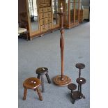 A stained pine lobed baluster standard lamp; two three legged stools; a three tier jardinere stand.