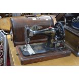 A Singer sewing machine in dome top mahogany case
