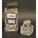An early 20th century silver mounted scent bottle, cut glass rectangular body, square hinged lid,
