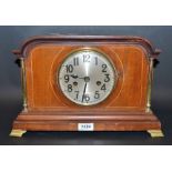 An inlaid mahogany mantel clock,