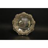 A silver shaped octagonal fluted bon-bon dish, embossed with floral scrolls, Sheffield 1900,