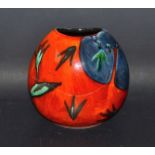 A Poole pottery vase in burnt orange and blue with abstract tulips design