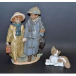 A Lladro model Off To School, No12242; another Suprised Cat, No05114,