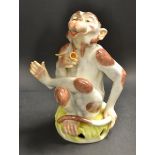 A modern Dresden model of an ape seated smoking a pipe, 24cm high, printed and impressed mark,