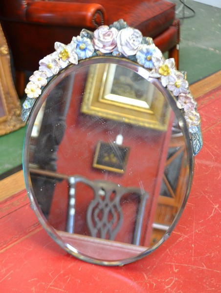 A 1930`s oval bevelled dressing table mirror, embellished with summer flowers to the frame.