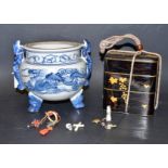 A Japanese black lacquered three section box; a miniature painted turtle; a silver dragon;