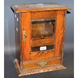 An early 20th century oak smoker's cabinet, single drawer to base, 40cm high,