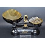 A set of brass and cast iron kitchen scales with a set of graduated bell shaped weighs