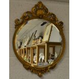 A circular wall mirror gesso moulded frame with scallop shell.