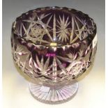 An amethyst flashed and clear cut glass pedestal fruit bowl