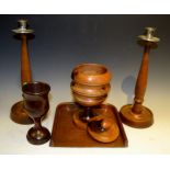 Treen - a pair of turned candlesticks; crumb tray; a turned goblet;