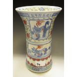 A Chinese gu beaker vase, decorated with temple lions,scrolls, trellis and script,
