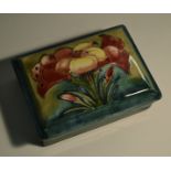 A Moorcroft Spring Flowers rectangular trinket box and cover, tube lined with flowers and foliage,