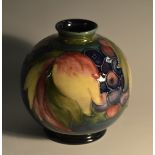 A Moorcroft Leaf and Berry pattern globular vase, ube lined with leaves and berries,