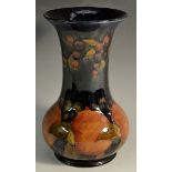 A Moorcroft Pomegranate pattern vase, tube lined with fruit, berries and foliage, in tones of red,