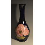 A Moorcroft Magnolia pattern bottle vase, tube lined with large flowerheads and foliage,