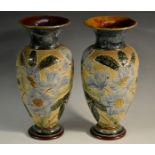 A pair of Doulton Slaters Patent baluster vases, tube lined with large blue flowerheads and foliage,