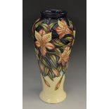 A contemporary Moorcroft Peruvian Lily pattern inverted baluster vase, in shades of salmon pink,