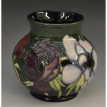 A contemporary Moorcroft Anemone Tribute pattern ovoid vase, tube lined with bold flower heads,