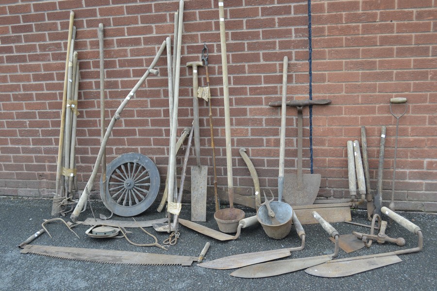 Vintage agricultural tools including peat spade; drag rake; scythe; post spade; hay knives;