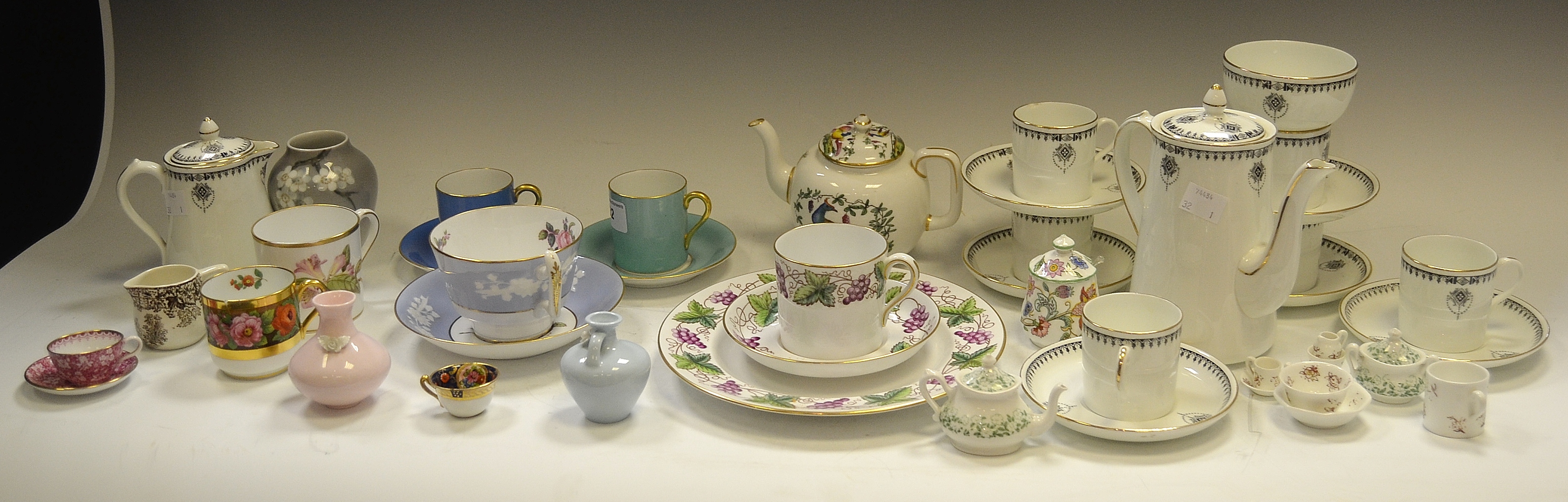 A Hancock's China Clarence pattern six-setting coffee service; a Spode miniature tea cup and saucer,