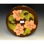 A Moorcroft Hibiscus pattern circular charger,
