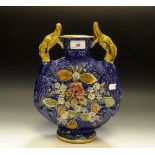 A continental majolica moon flask, blue ground, applied with flowers,